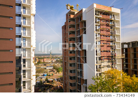 Aerial view of multi storey residential apartment buildings under construction. Real estate development. Aerial view of multi storey residential apartment buildings under construction. Real estate development. 73434149