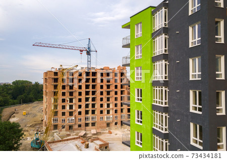 Aerial view of city residential area with high apartment buildings under construction. Aerial view of city residential area with high apartment buildings under construction. 73434181