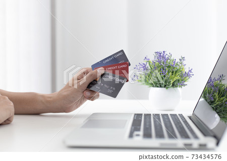 Men use laptop to register online purchases using credit card payments, Convenience in the world of technology and the internet, Shopping online and banking online concept. 73434576
