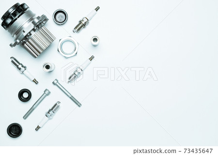 Car service. Auto motor mechanic spare or automotive piece on white background. Set of new metal car part. Repair and vehicle service with space for text. 73435647