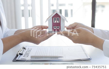 Real estate broker has given the house to customers who bought the house with insurance, Negotiating purchase-sale and investment planning concept. 73435751
