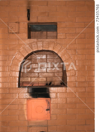 Russian stove close-up with ash from the fire and a place for cooking 73435768