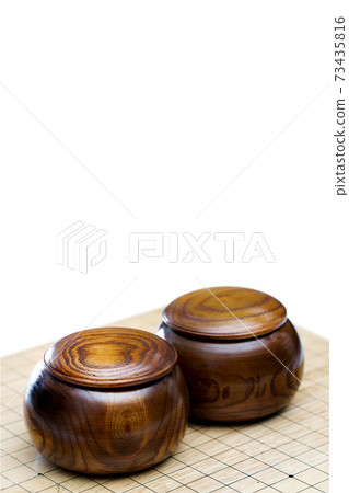 Go game stones in wooden bowls on Board Game with text space Go game stones in wooden bowls on Board Game with text space 73435816
