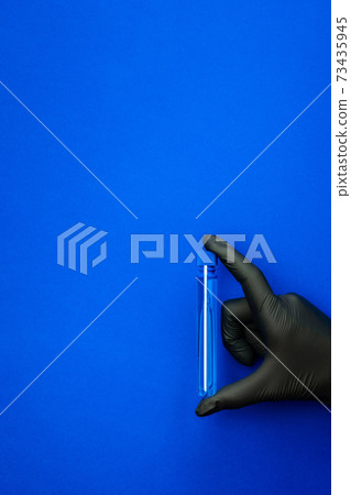 Syringe isolated. Doctor hand in medical glove hold test tube or bottle for protection flu virus and coronavirus. Covid vaccine isolated on blue. Concept fight against virus covid-19. Syringe isolated. Doctor hand in medical glove hold test tube or bottle for protection flu virus and coronavirus. Covid vaccine isolated on blue. Concept fight against virus covid-19. 73435945