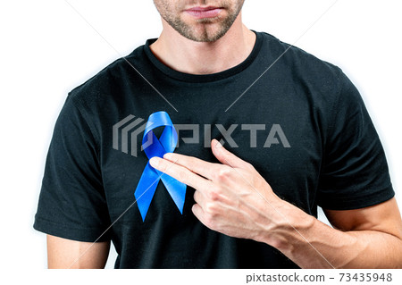 Blue prostate ribbon. Awareness cancer of men health. Hipster men in black shirt with blue ribbon in hands isolated on white background. November and International Mens Day. Blue prostate ribbon. Awareness cancer of men health. Hipster men in black shirt with blue ribbon in hands isolated on white background. November and International Mens Day. 73435948