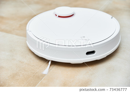 Robot vacuum cleaner working on the floor, top view. Modern smart household Robot vacuum cleaner working on the floor, top view. Modern smart household 73436777