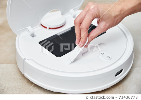 Repair robot vacuum cleaner, closeup. Household appliance service Repair robot vacuum cleaner, closeup. Household appliance service 73436778
