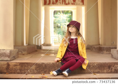 Irish little red haired girl outdoor photo on park architecture background Irish little red haired girl outdoor photo on park architecture background 73437136