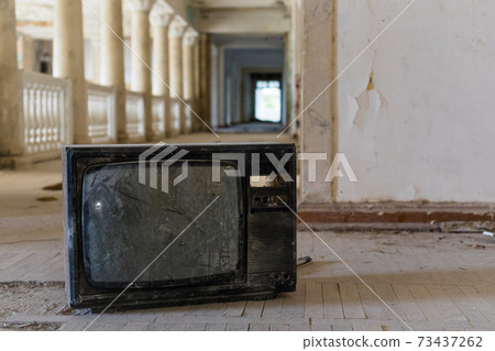 Broken television set in the interior of abandoned building of the Soviet sanatorium Georgia in Gagra, Abkhazia Broken television set in the interior of abandoned building of the Soviet sanatorium Georgia in Gagra, Abkhazia 73437262