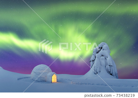 Wintry scene with glowing polar lights and snowy igloo Wintry scene with glowing polar lights and snowy igloo 73438219