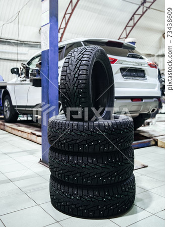 set of new car wheels at a shallow depth of field 73438609