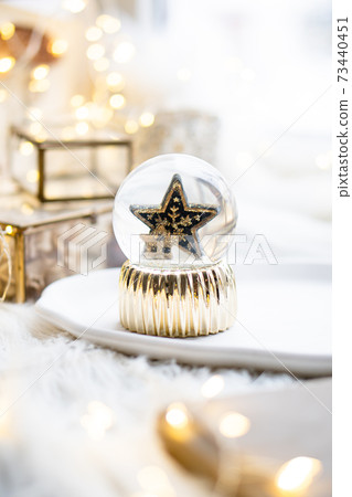 Gold christmas star in glass ball, new year decoration Gold christmas star in glass ball, new year decoration 73440451