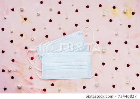 Medical masks on romantic backround with hearts 73440827