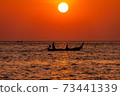 Longtail boat in the sunset. 73441339