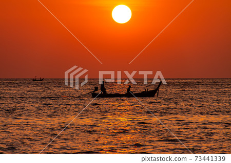 Longtail boat in the sunset. 73441339