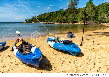 Blue kayaks on the beach 73441344