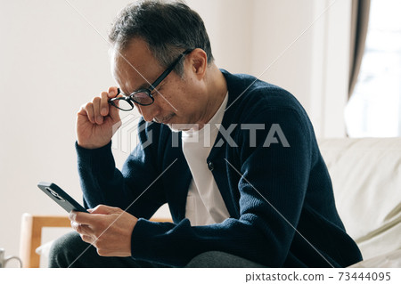 Image of dry eye, presbyopia, eyestrain, and eye fatigue caused by smartphones 73444095