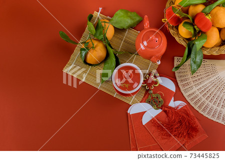 Asian festival decorations on red Ang Pau money packet,chinese new year decorations, and tangerines Good Luck Asian festival decorations on red Ang Pau money packet,chinese new year decorations, and tangerines Good Luck 73445825