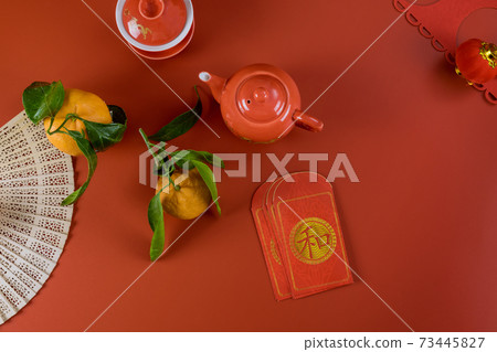 Lunar Chinese New Year celebrations symbol decorations ornament, with Asian tea set money packet Ang Pau on red background Lunar Chinese New Year celebrations symbol decorations ornament, with Asian tea set money packet Ang Pau on red background 73445827
