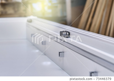 White cabinet with hidden hinges and shelf holders. Wooden furniture manufacturing process White cabinet with hidden hinges and shelf holders. Wooden furniture manufacturing process 73446379
