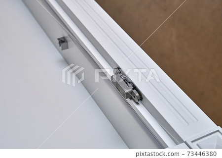 White cabinet with hidden hinges and shelf holders. Wooden furniture manufacturing process White cabinet with hidden hinges and shelf holders. Wooden furniture manufacturing process 73446380