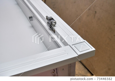 White cabinet with hidden hinges and shelf holders. Wooden furniture manufacturing process White cabinet with hidden hinges and shelf holders. Wooden furniture manufacturing process 73446382
