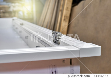 White cabinet with hidden hinges and shelf holders. Wooden furniture manufacturing process White cabinet with hidden hinges and shelf holders. Wooden furniture manufacturing process 73446383