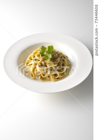 Photographed flat pasta with truffle cream with trefoil on a white background Photographed flat pasta with truffle cream with trefoil on a white background 73446608