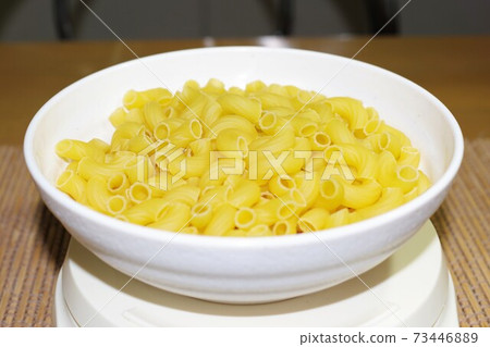 Weighing macaroni Weighing macaroni 73446889