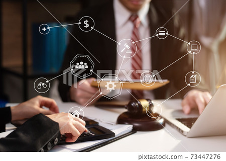 Justice and law concept.Male judge in a courtroom the gavel, working with digital tablet computer on wood table in sun light. Justice and law concept.Male judge in a courtroom the gavel, working with digital tablet computer on wood table in sun light. 73447276