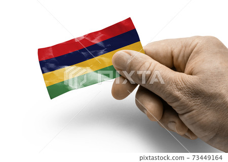 Hand holding a card with a national flag the Mauritius Hand holding a card with a national flag the Mauritius 73449164