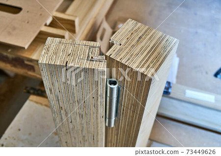 Joinery. Wood door manufacturing process. Door hinge installation. Furniture manufacture Joinery. Wood door manufacturing process. Door hinge installation. Furniture manufacture 73449626