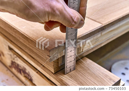 Joinery. Door leaf measure with a ruler. Wood door manufacturing process. Furniture manufacture 73450103
