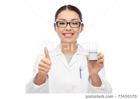 smiling asian female doctor or nurse with medicine smiling asian female doctor or nurse with medicine 73450370