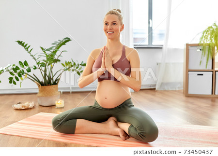 pregnant woman meditating at home pregnant woman meditating at home 73450437