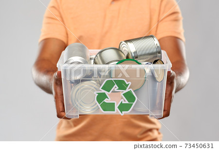 close up of young man sorting metallic waste close up of young man sorting metallic waste 73450631