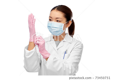 asian female doctor in medical mask and gloves 73450731