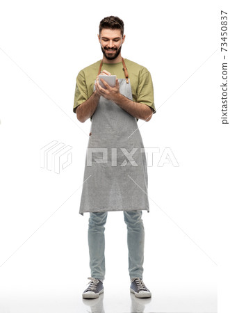 smiling waiter in apron taking notes to notepad smiling waiter in apron taking notes to notepad 73450837