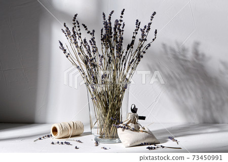 sachet bag, rope and lavender flowers in vase sachet bag, rope and lavender flowers in vase 73450991