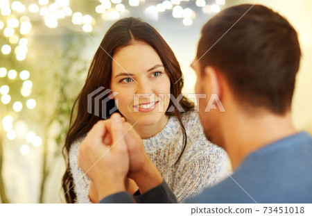 happy couple holding hands at restaurant or cafe happy couple holding hands at restaurant or cafe 73451018