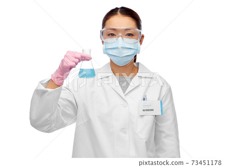 asian female scientist in mask with chemical 73451178