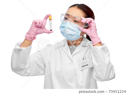 asian female doctor holding beaker with blood test 73451224