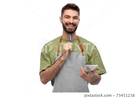 smiling waiter in apron with pen and notepad smiling waiter in apron with pen and notepad 73451238