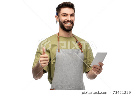 smiling waiter in apron taking notes to notepad smiling waiter in apron taking notes to notepad 73451239