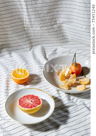 still life with mandarins and grapefruit on plate still life with mandarins and grapefruit on plate 73451240