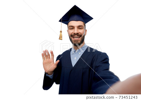 smiling male graduate student taking selfie smiling male graduate student taking selfie 73451243