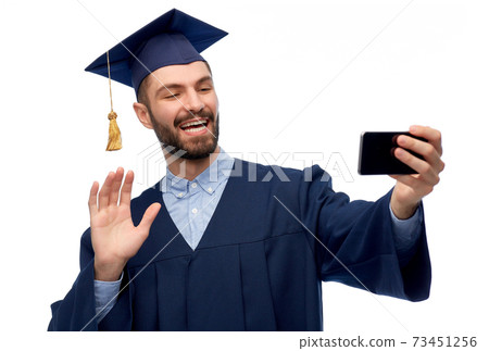 male graduate student with smartphone takes selfie 73451256