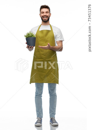 happy smiling male gardener with flower in pot happy smiling male gardener with flower in pot 73451376
