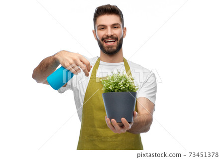 happy smiling male gardener moisturizing flower happy smiling male gardener moisturizing flower 73451378
