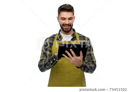 happy male gardener or farmer with tablet pc 73451502